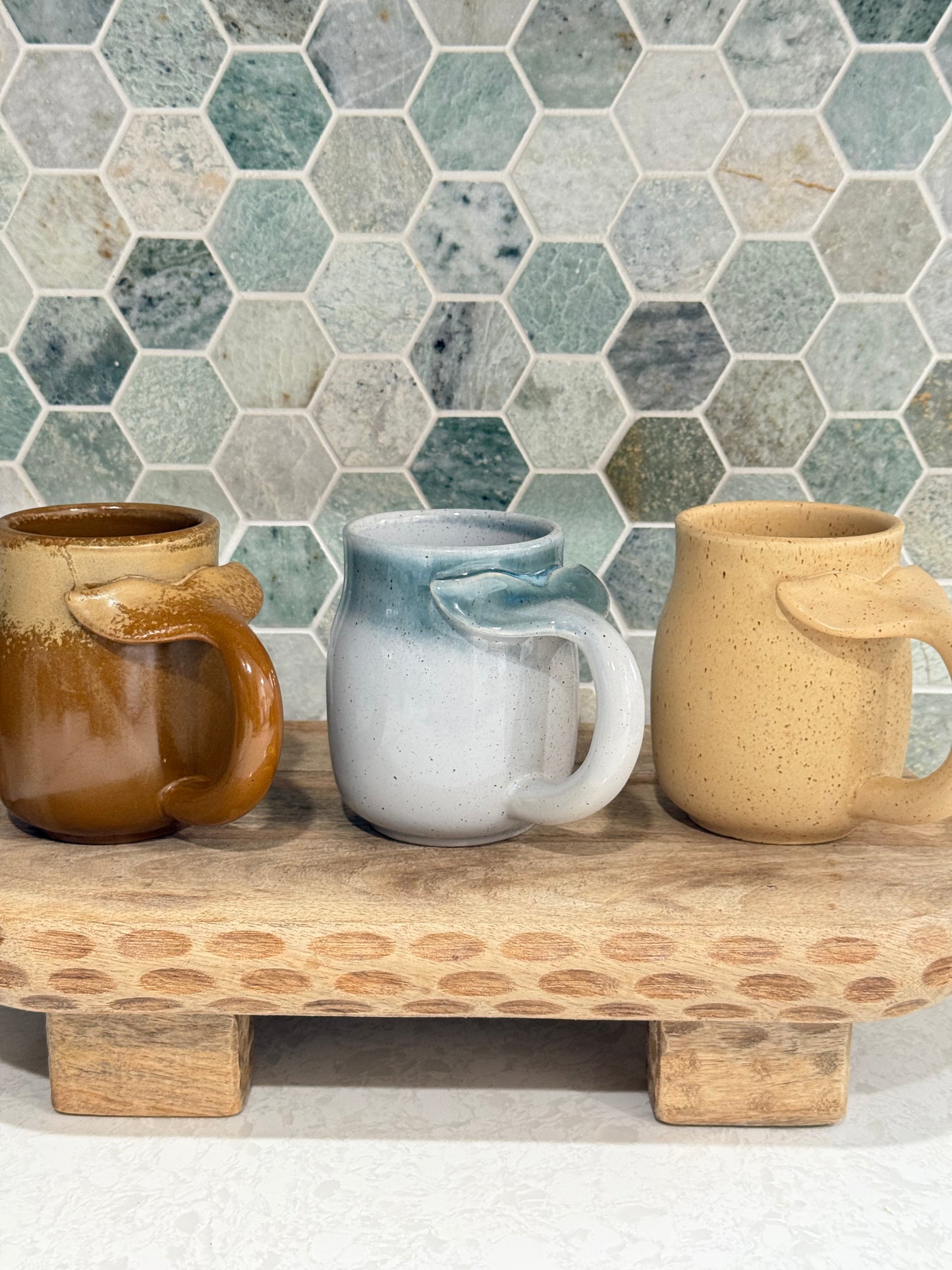 ocean-themed stoneware mugs in color options; ocean, camel and sand.